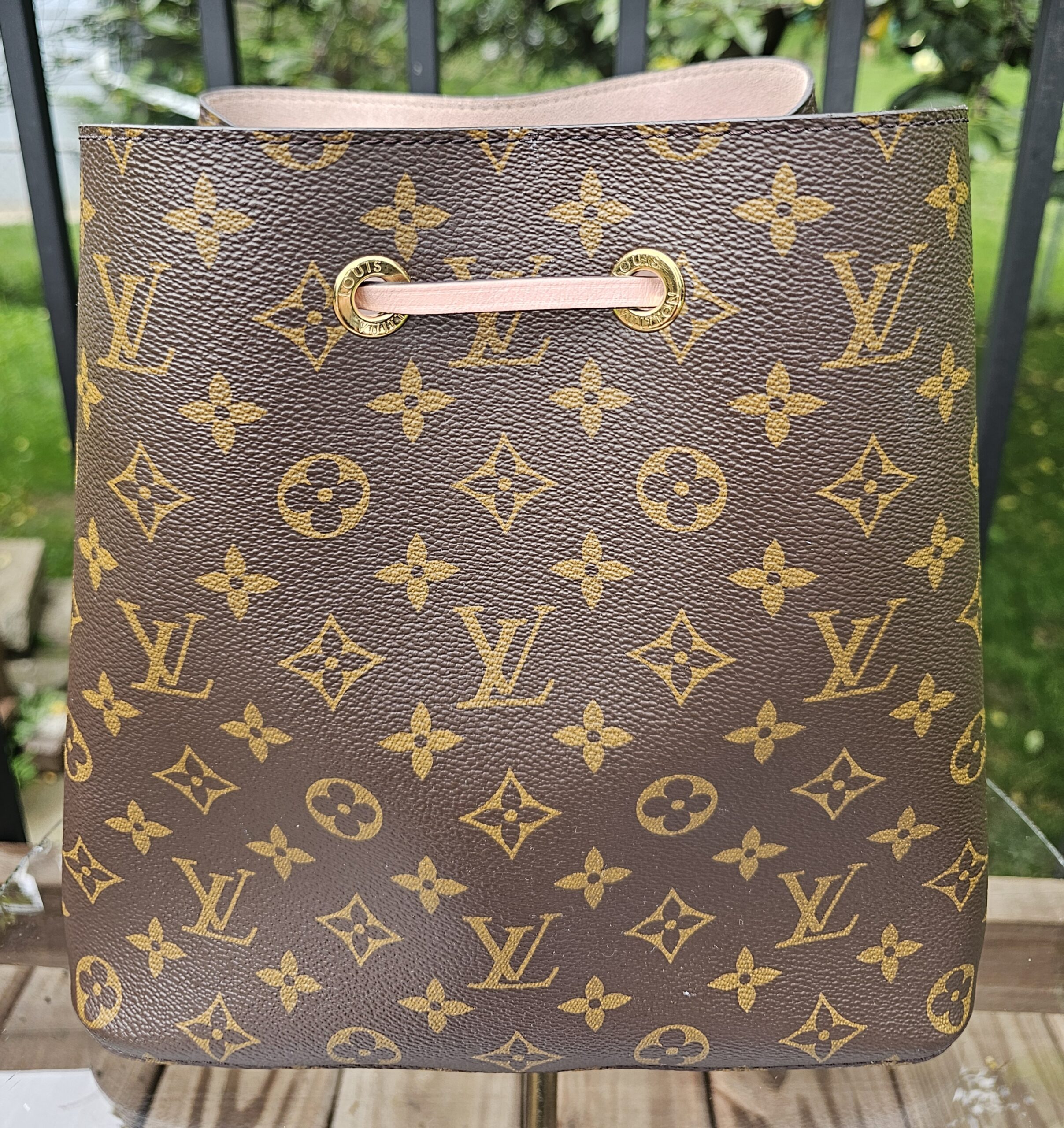 Front view of the Louis Vuitton Monogram NeoNoe MM showing the bright Monogram canvas and pink trim