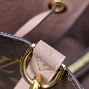 Gold-tone eyelet and ring hardware on the Louis Vuitton Monogram NeoNoe MM