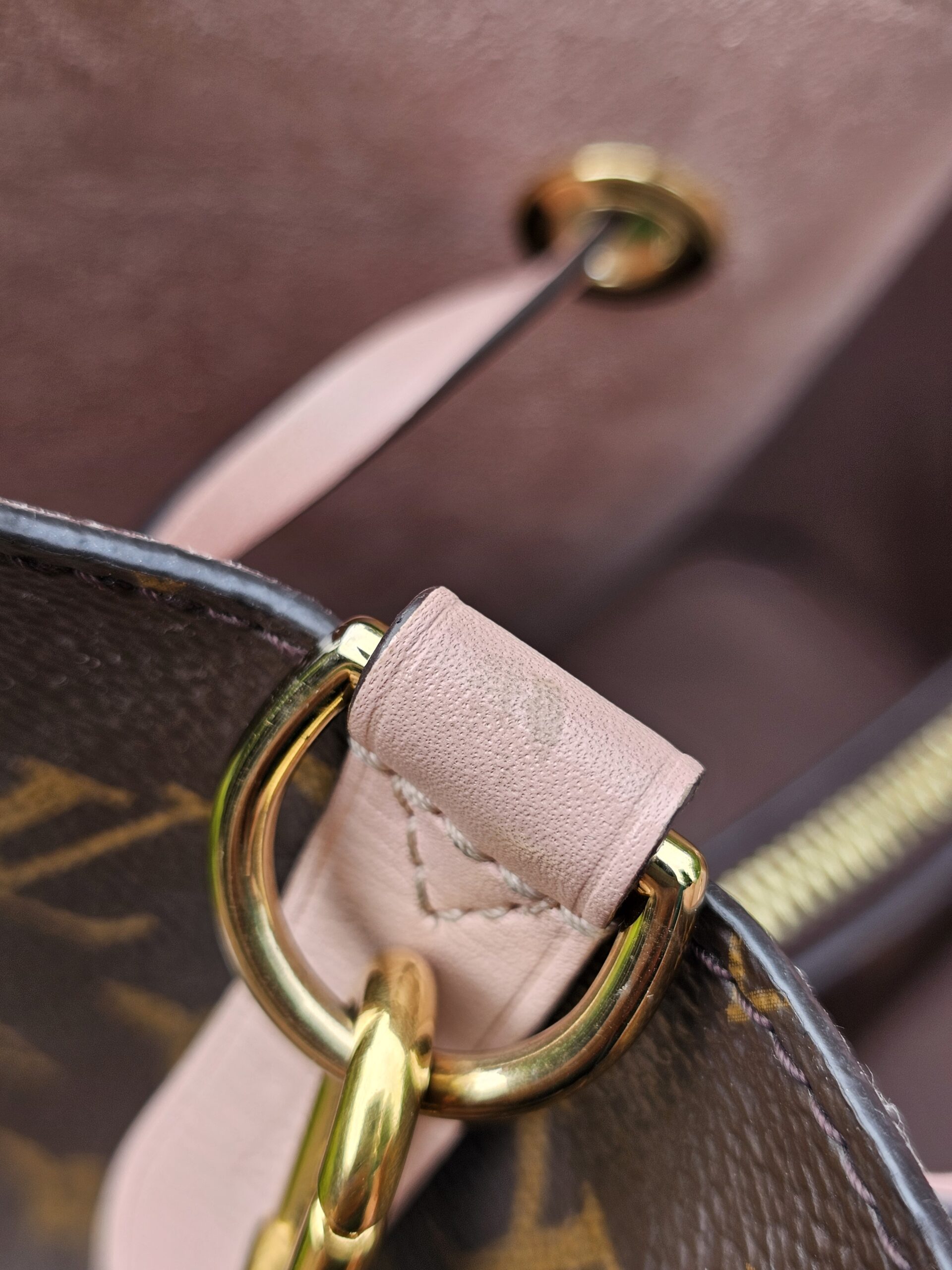Gold-tone eyelet and ring hardware on the Louis Vuitton Monogram NeoNoe MM