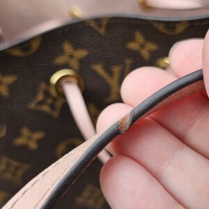 Top edge of the Louis Vuitton Monogram NeoNoe MM showing rubbing to the pink leather trim
