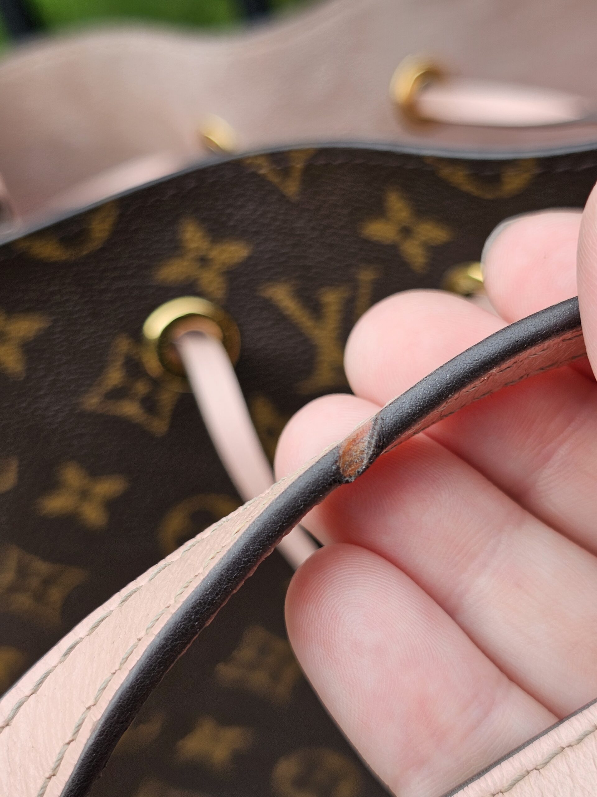 Top edge of the Louis Vuitton Monogram NeoNoe MM showing rubbing to the pink leather trim