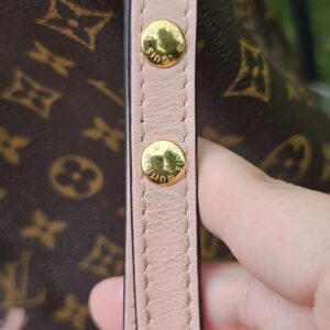 Gold-tone studs on the Rose Poudre leather trim of the Louis Vuitton NeoNoe MM