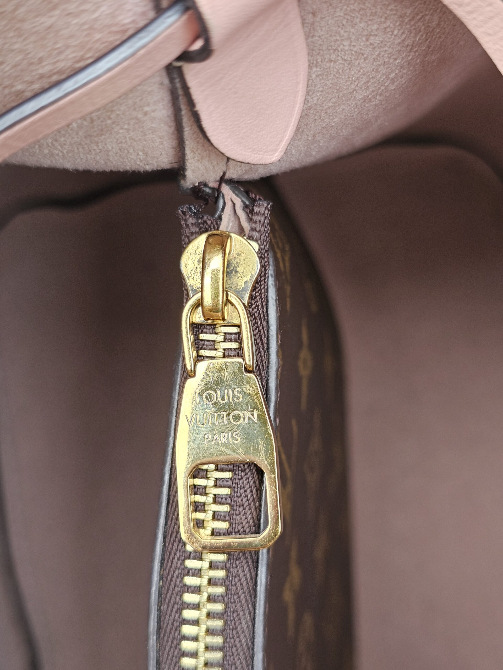 Gold-tone LV engraved zip pull inside the Louis Vuitton Monogram NeoNoe MM