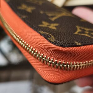 Monogram canvas meeting the Piment orange cowhide leather on the Louis Vuitton Zippy Multicartes