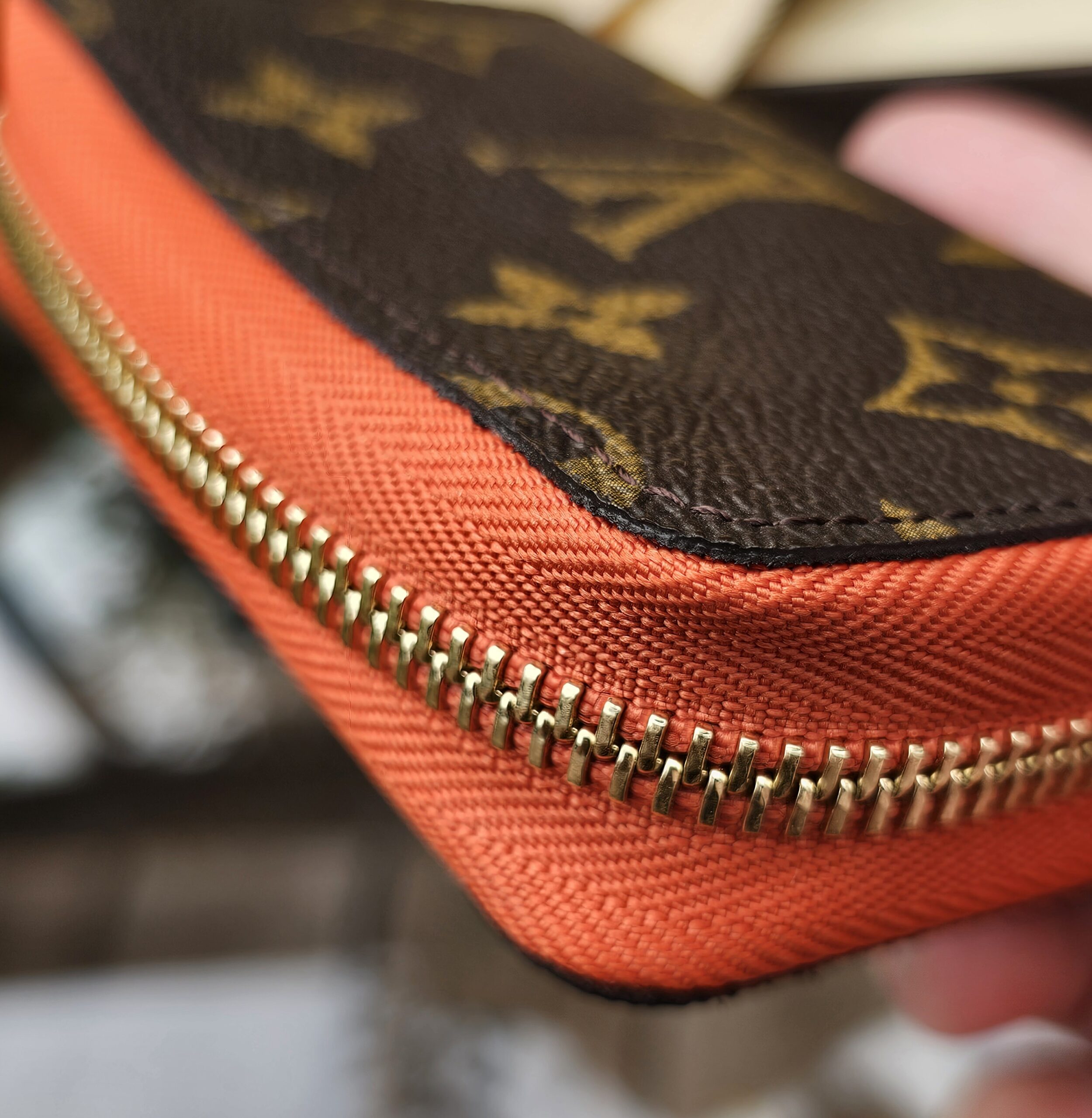 Monogram canvas meeting the Piment orange cowhide leather on the Louis Vuitton Zippy Multicartes