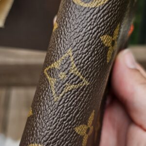 Louis Vuitton Monogram Zippy Multicartes held in hand to show scale