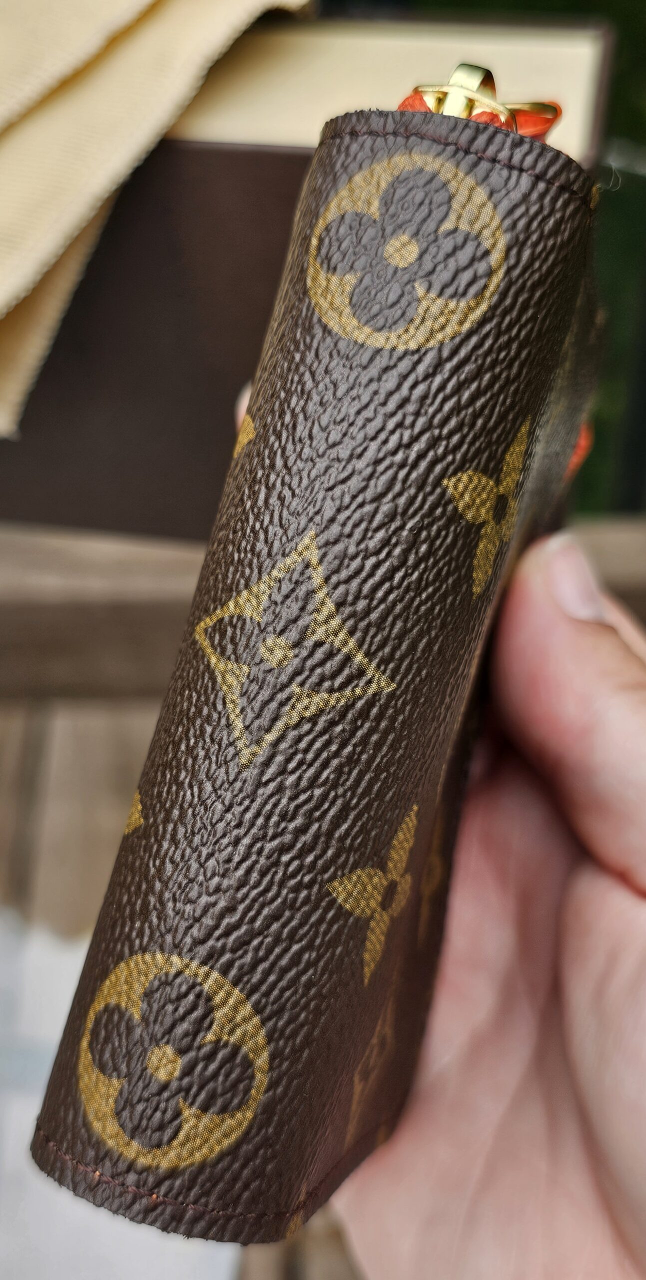 Louis Vuitton Monogram Zippy Multicartes held in hand to show scale