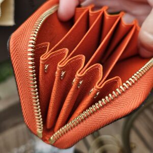 Accordion style card compartments in Piment orange leather inside the Louis Vuitton Zippy Multicartes