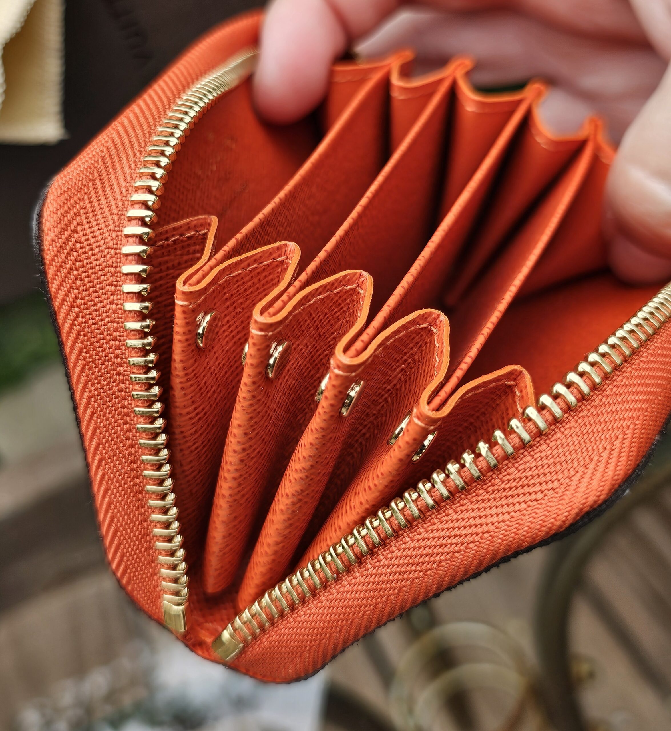 Accordion style card compartments in Piment orange leather inside the Louis Vuitton Zippy Multicartes