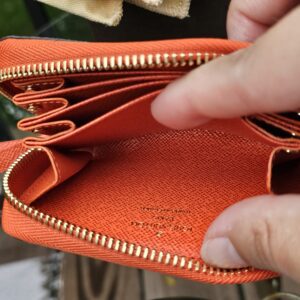 Interior compartments of the Louis Vuitton Zippy Multicartes in Piment orange leather