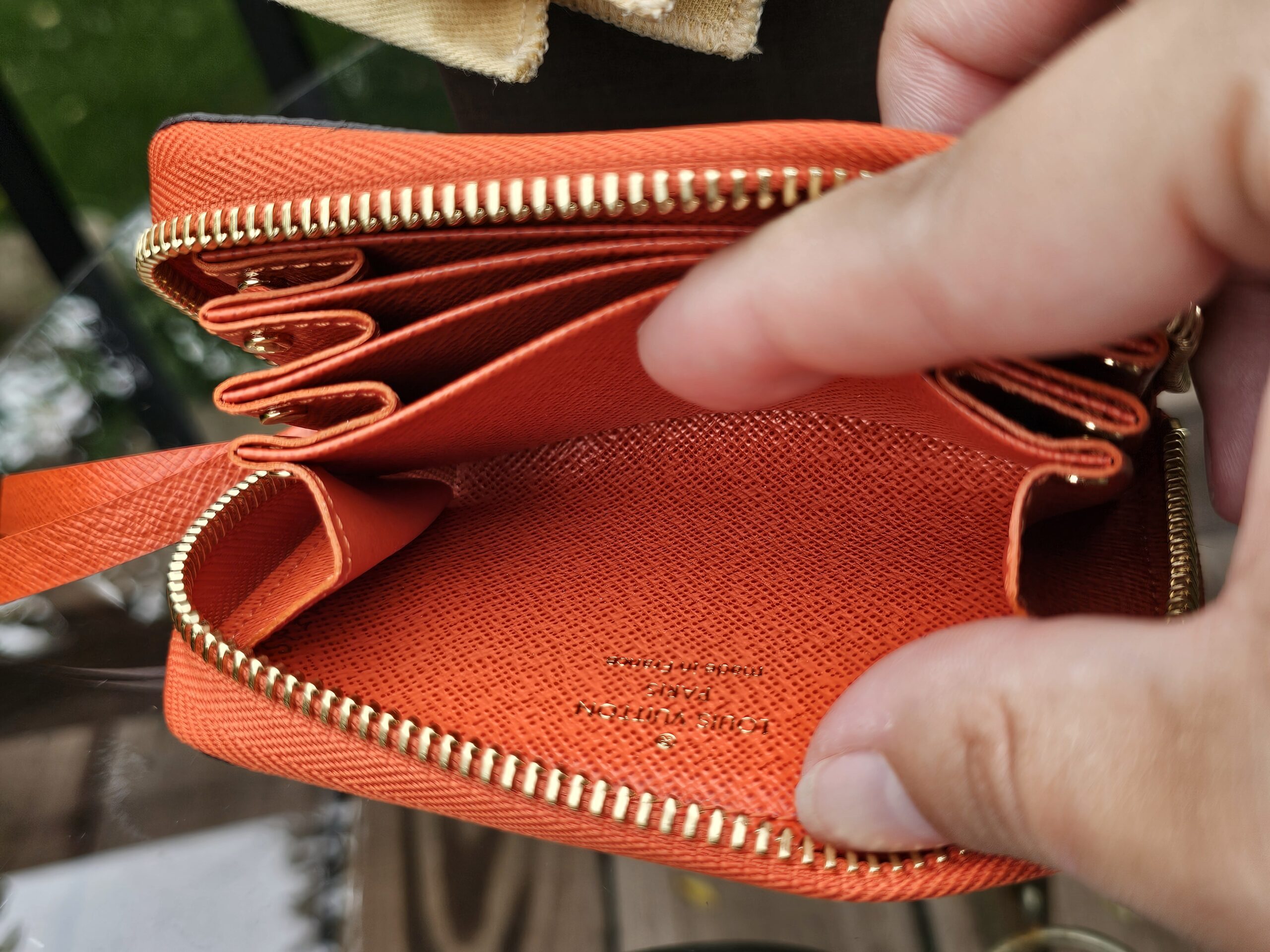 Interior compartments of the Louis Vuitton Zippy Multicartes in Piment orange leather