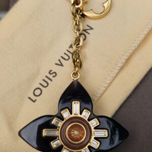 Louis Vuitton Fleur d Etoile key holder and bag charm with a black resin flower, crystals and gold-tone clasp