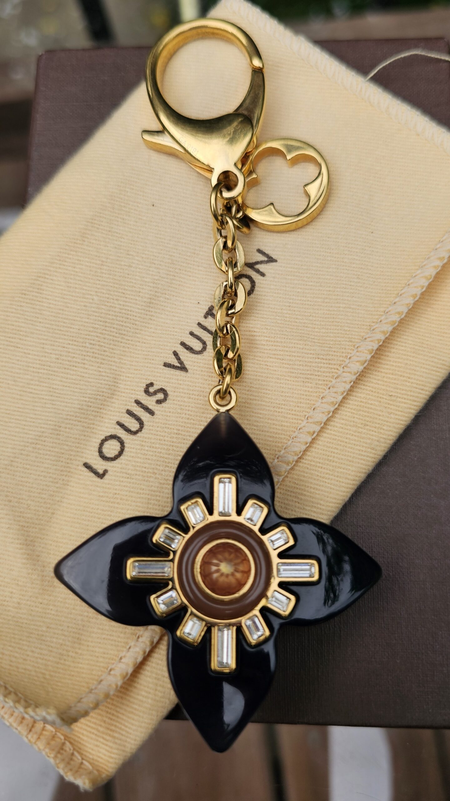 Louis Vuitton Fleur d Etoile key holder and bag charm with a black resin flower, crystals and gold-tone clasp