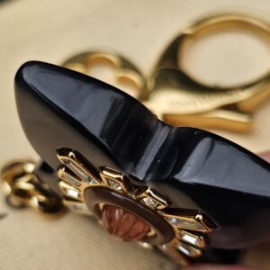 Side profile of the glossy black resin flower on the Louis Vuitton Fleur d Etoile charm