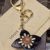 Full view of the Louis Vuitton Fleur d Etoile key holder and bag charm with chain and clasp