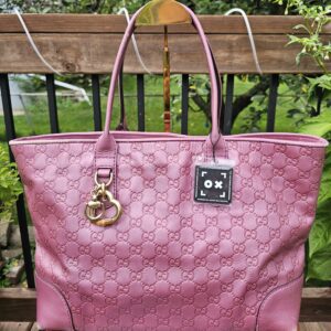 Front view of the Gucci Large Heart Bit tote in pink Guccissima leather with the heart charm