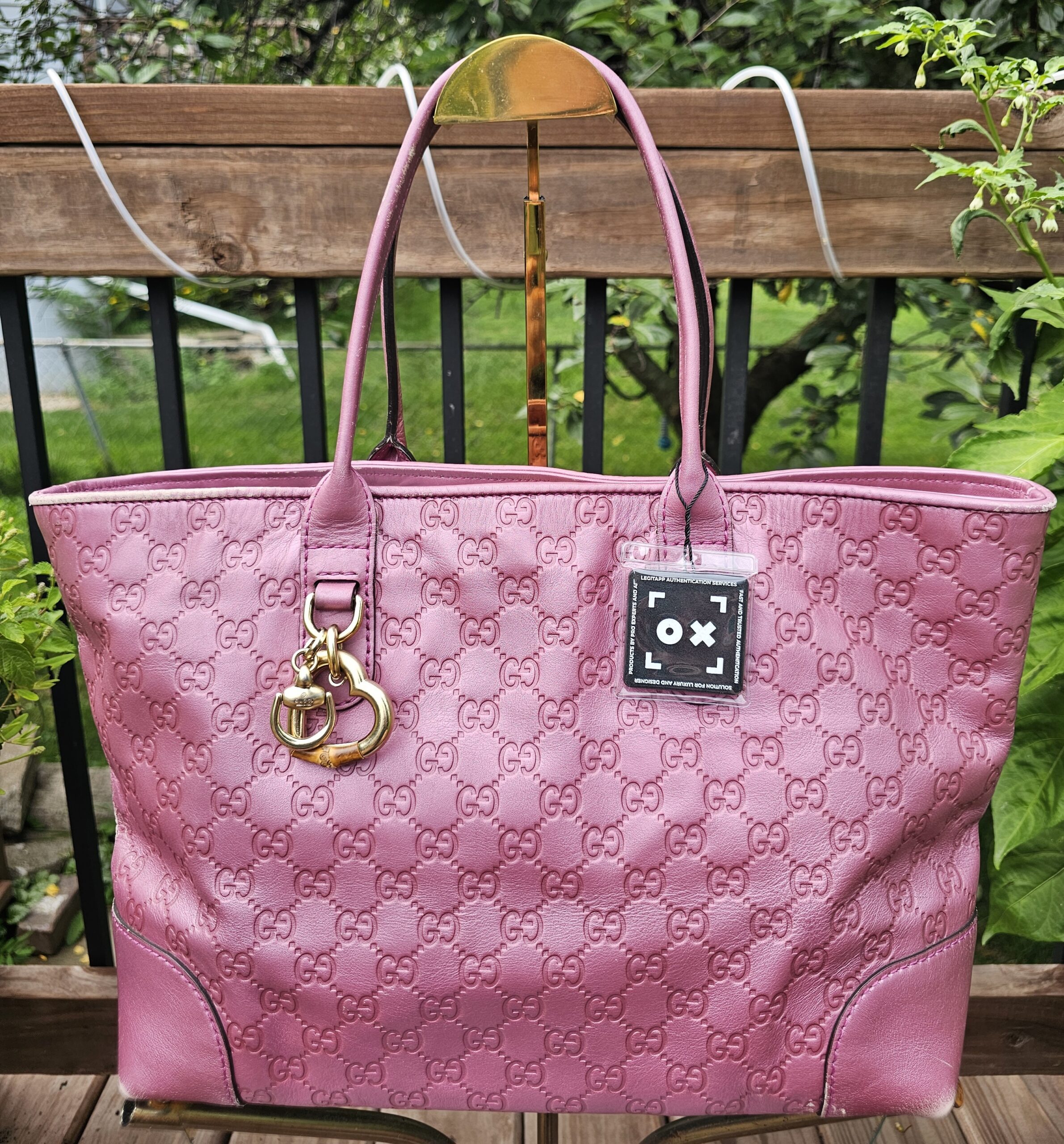 Front view of the Gucci Large Heart Bit tote in pink Guccissima leather with the heart charm