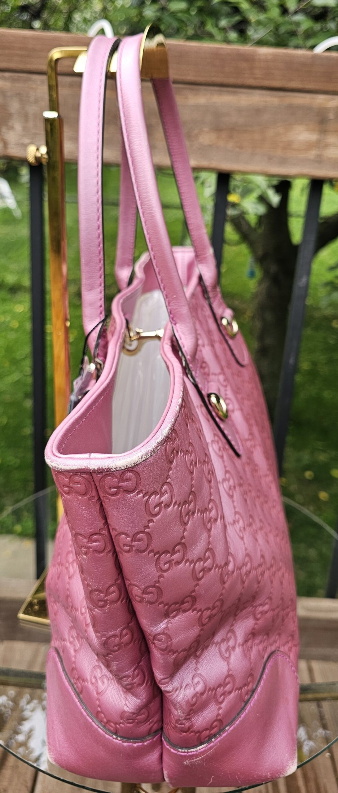 Side of the pink Guccissima Heart Bit tote showing the embossed GG pattern