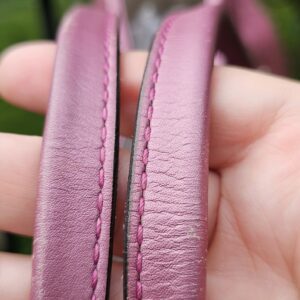 Dual pink leather shoulder handles of the Gucci Heart Bit tote