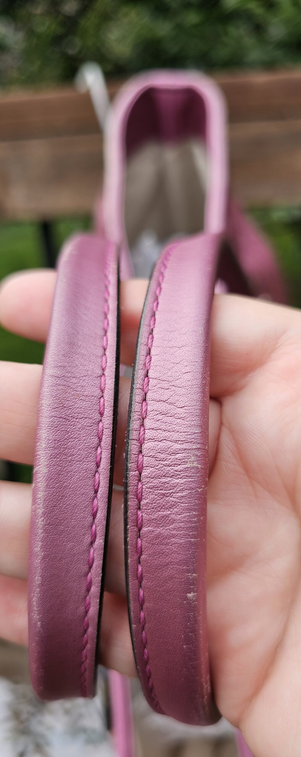 Dual pink leather shoulder handles of the Gucci Heart Bit tote