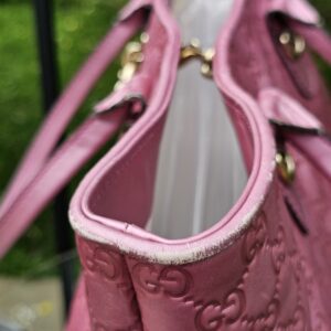 Open top of the Gucci Heart Bit tote showing the light canvas interior