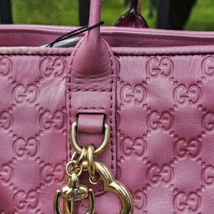 Heart Bit charm with bamboo detail hanging from the pink Guccissima tote