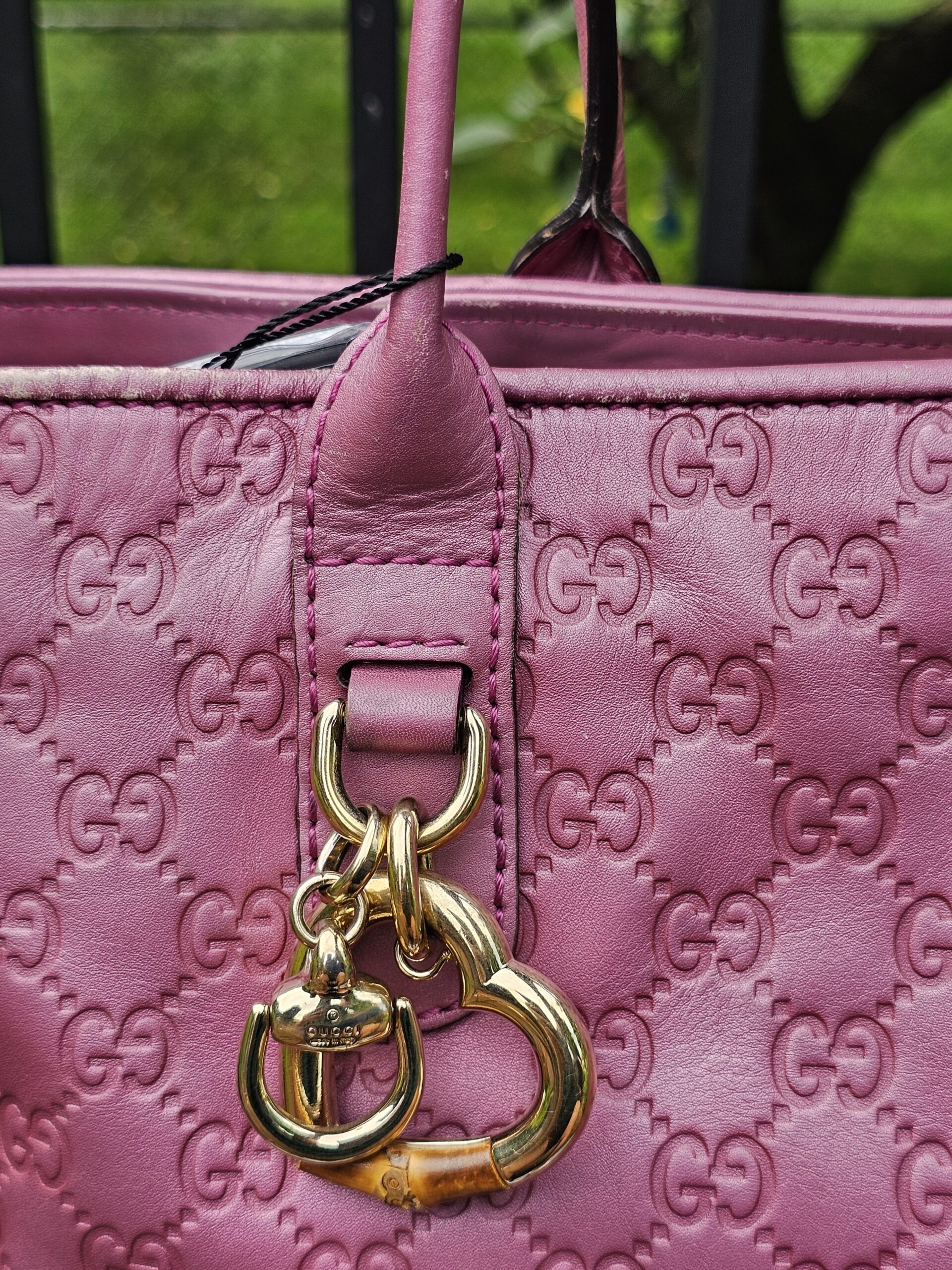 Heart Bit charm with bamboo detail hanging from the pink Guccissima tote