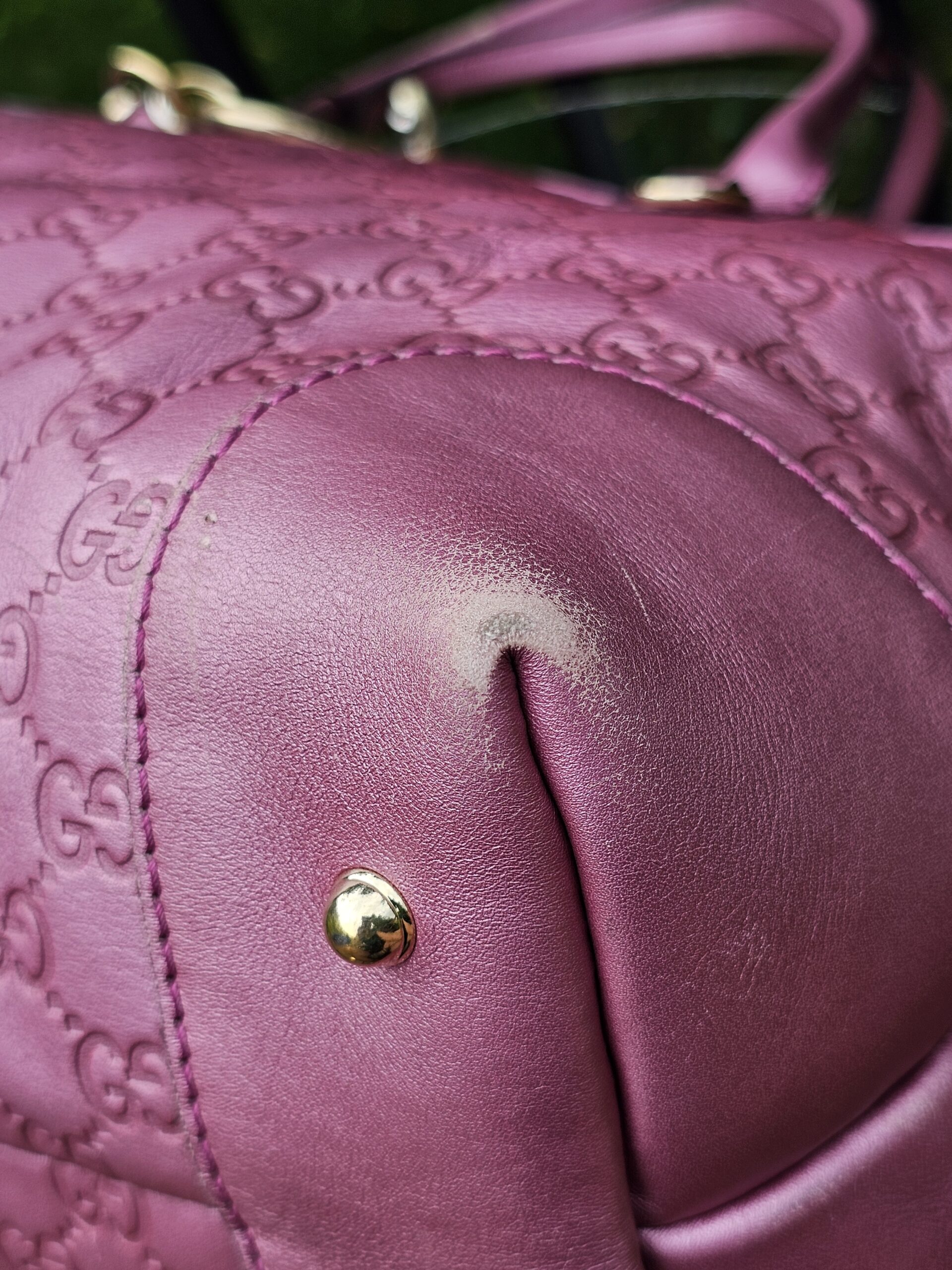 Corner of the pink Guccissima tote showing rubbing and colour loss from use