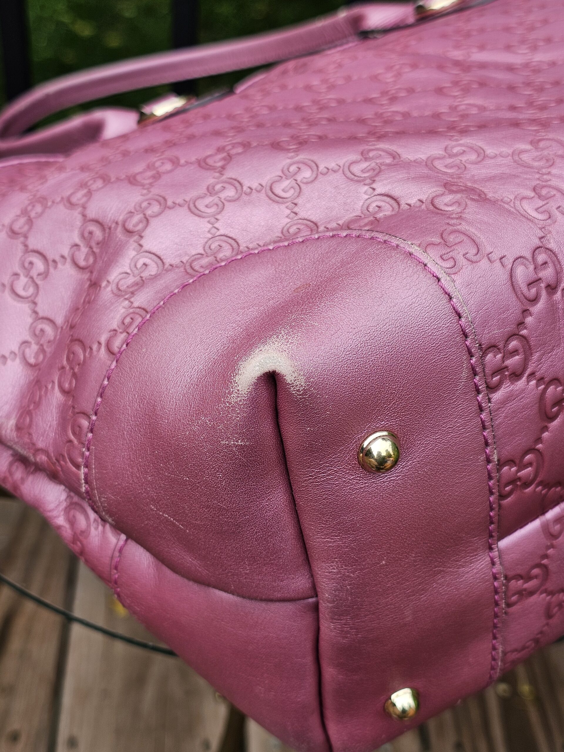 Bottom corner and metal foot of the Gucci Heart Bit tote shown for condition