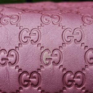 Close-up of the embossed GG Guccissima pattern in pink leather