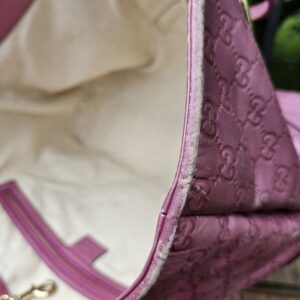 Canvas interior of the Gucci Heart Bit tote shown for light marks from use