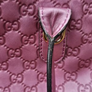 Interior zip pull of the Gucci Guccissima Large Heart Bit tote