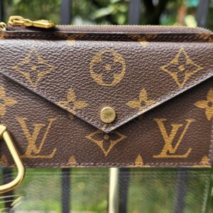 Louis Vuitton Monogram Recto Verso card holder showing the envelope snap flap in Monogram coated canvas with a gold key clip