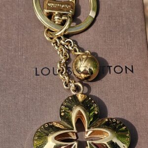 Louis Vuitton Eclipse key holder and bag charm in gold-tone metal with the Monogram flower charm and LV sphere