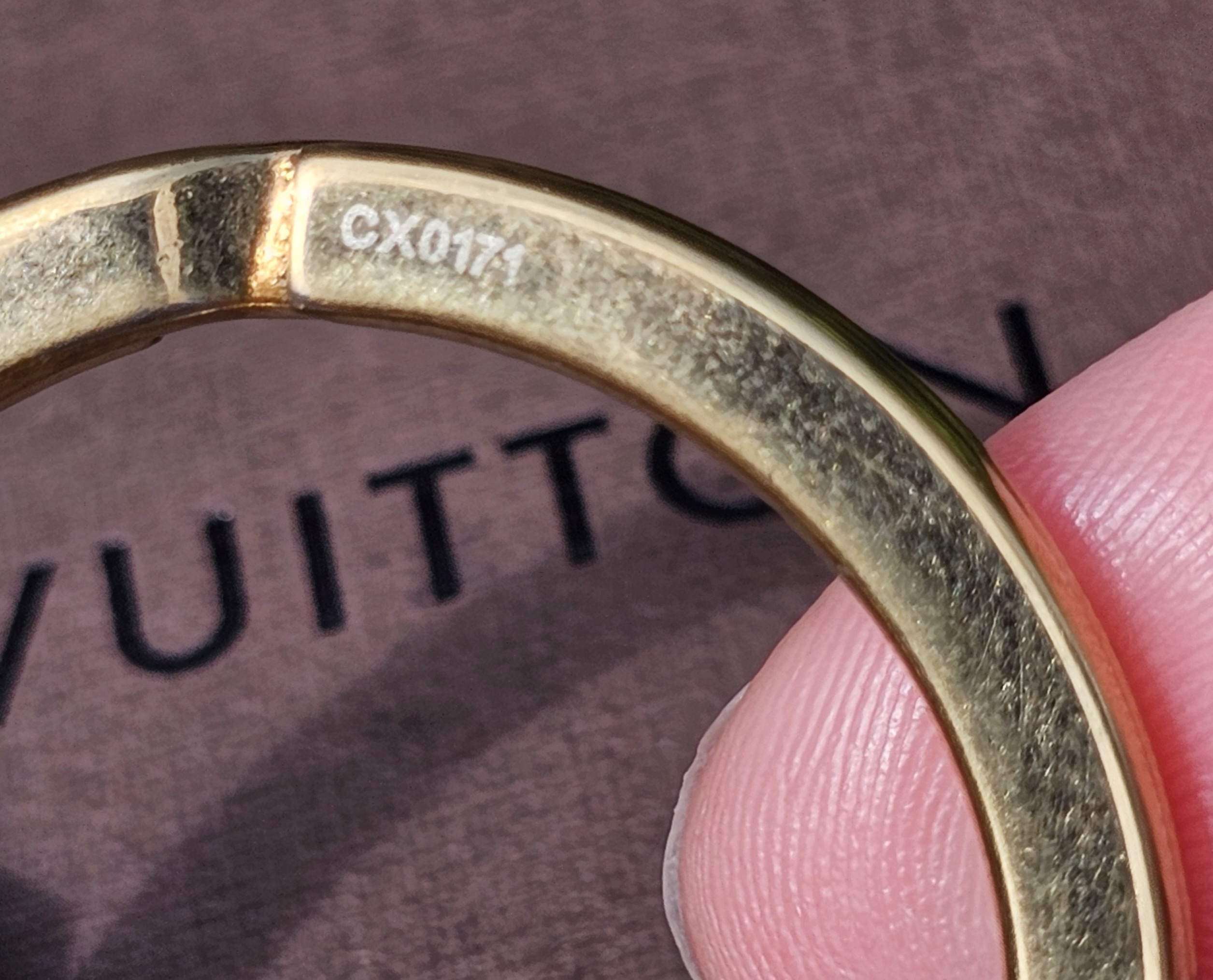 Code CX0171 engraved on the ring of the Louis Vuitton Eclipse gold-tone key holder and bag charm