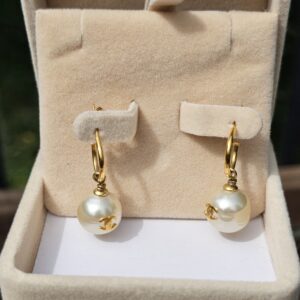Chanel faux pearl drop earrings with gold-tone hoops displayed in their box