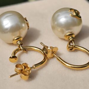 Chanel faux pearl pierced drop earrings shown with their gold-tone butterfly backs