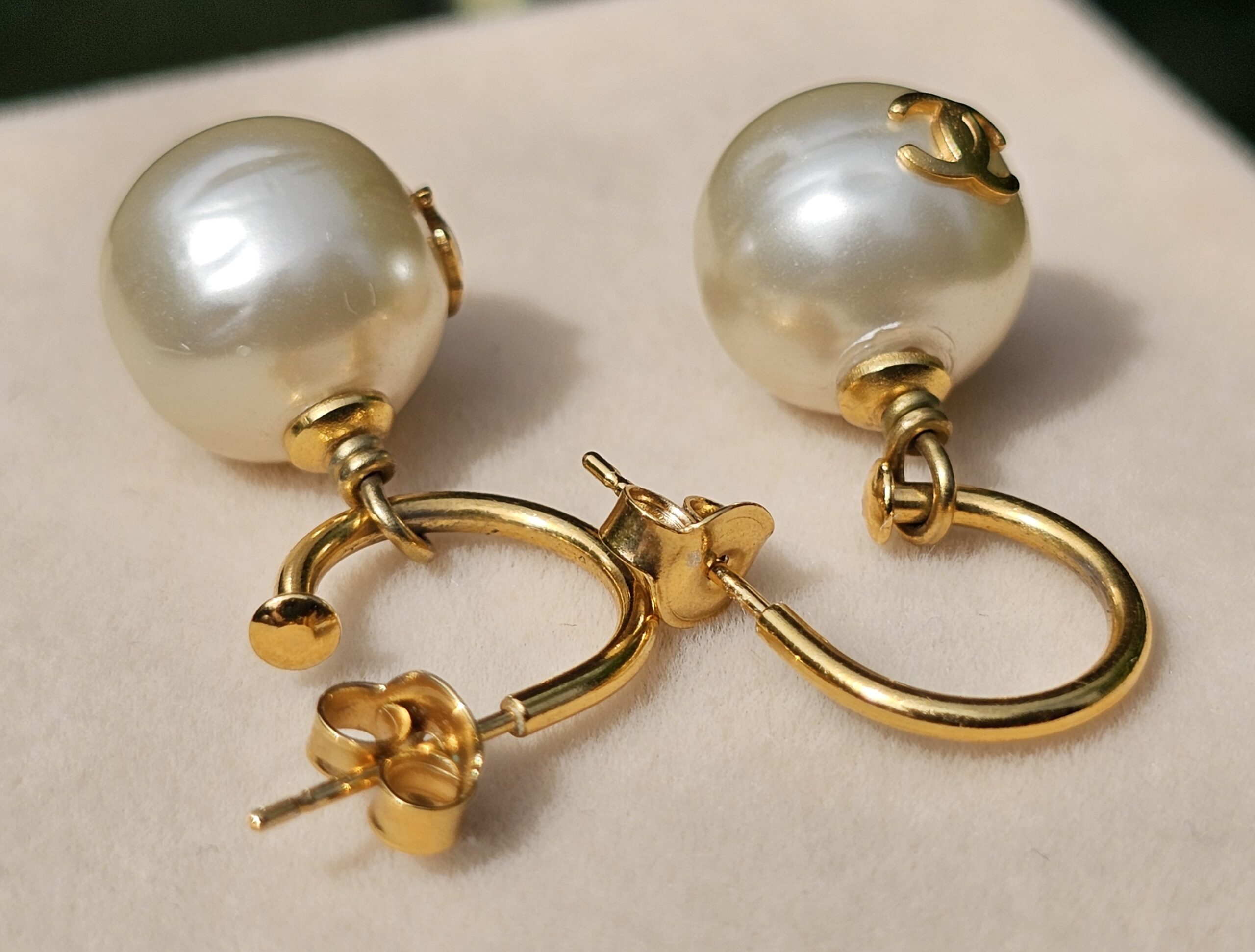 Chanel faux pearl pierced drop earrings shown with their gold-tone butterfly backs