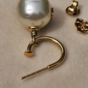 Single Chanel faux pearl drop earring with gold-tone hoop and butterfly backs alongside