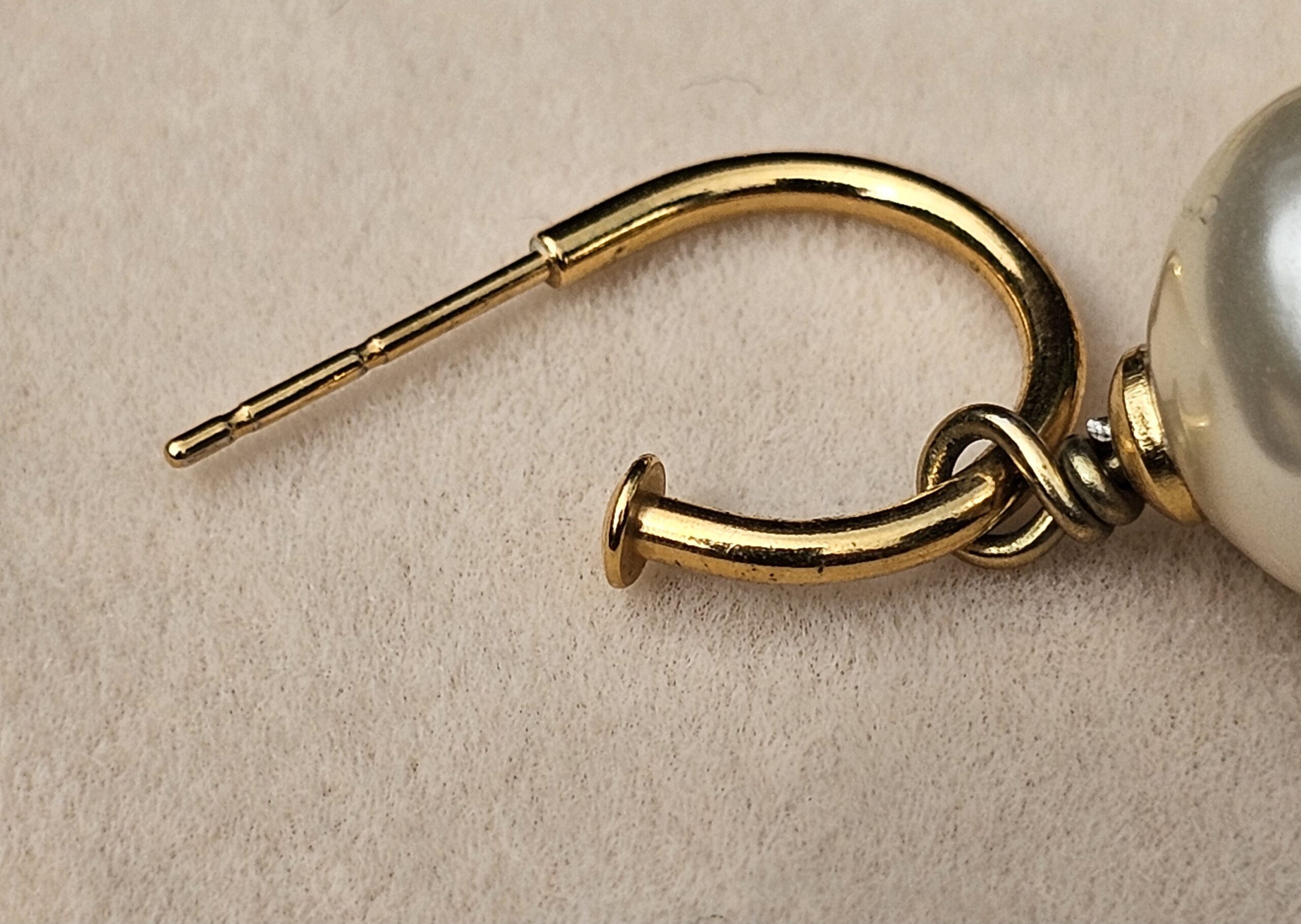 Pierced post and gold-tone hoop of the Chanel faux pearl drop earring