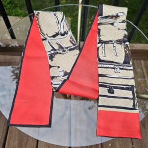 Full length of the Louis Vuitton Silk Monogram Trunks bandeau showing the trunk print and red ends