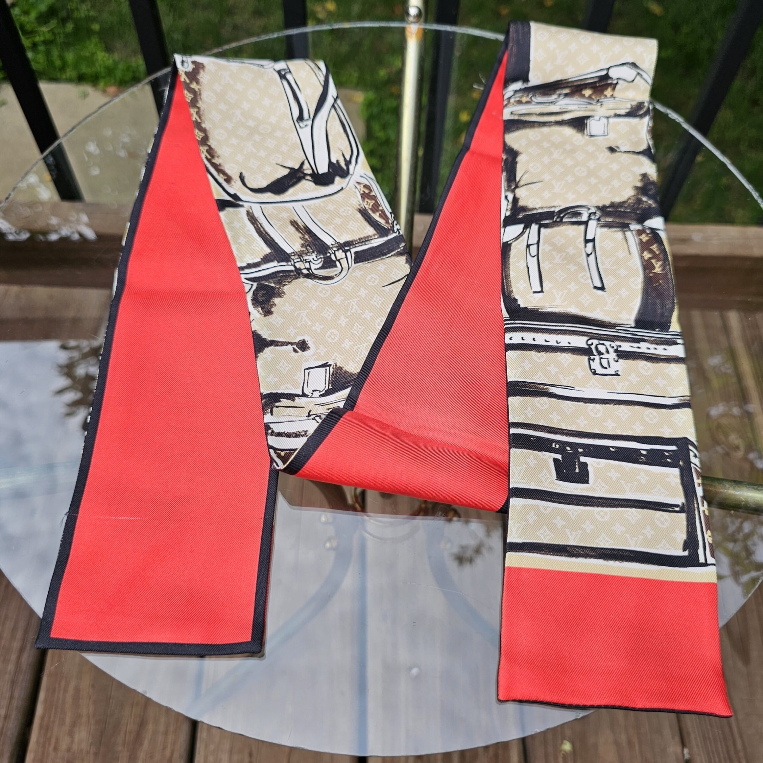 Full length of the Louis Vuitton Silk Monogram Trunks bandeau showing the trunk print and red ends