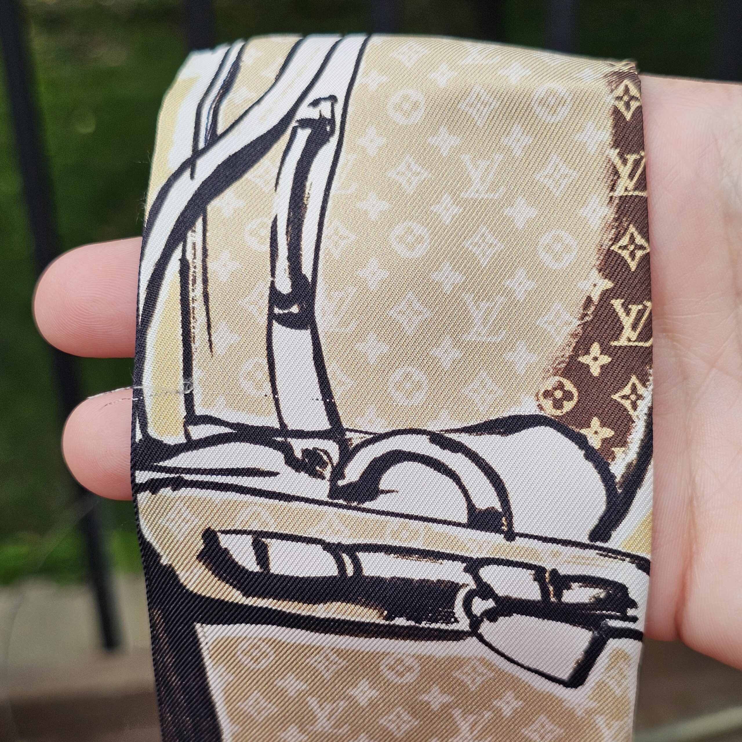 Close-up of the Monogram luggage print on the Louis Vuitton silk Trunks bandeau
