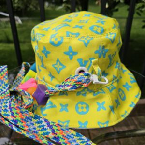 Side view of the yellow Louis Vuitton Virgil Abloh bucket hat with the multicolor braided cord