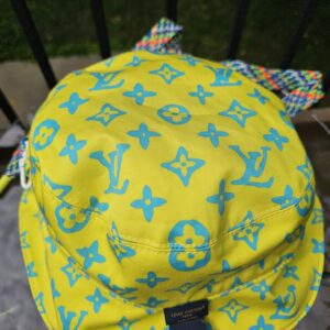 Close-up of the blue Monogram Playground print on the yellow cotton of the Louis Vuitton bucket hat