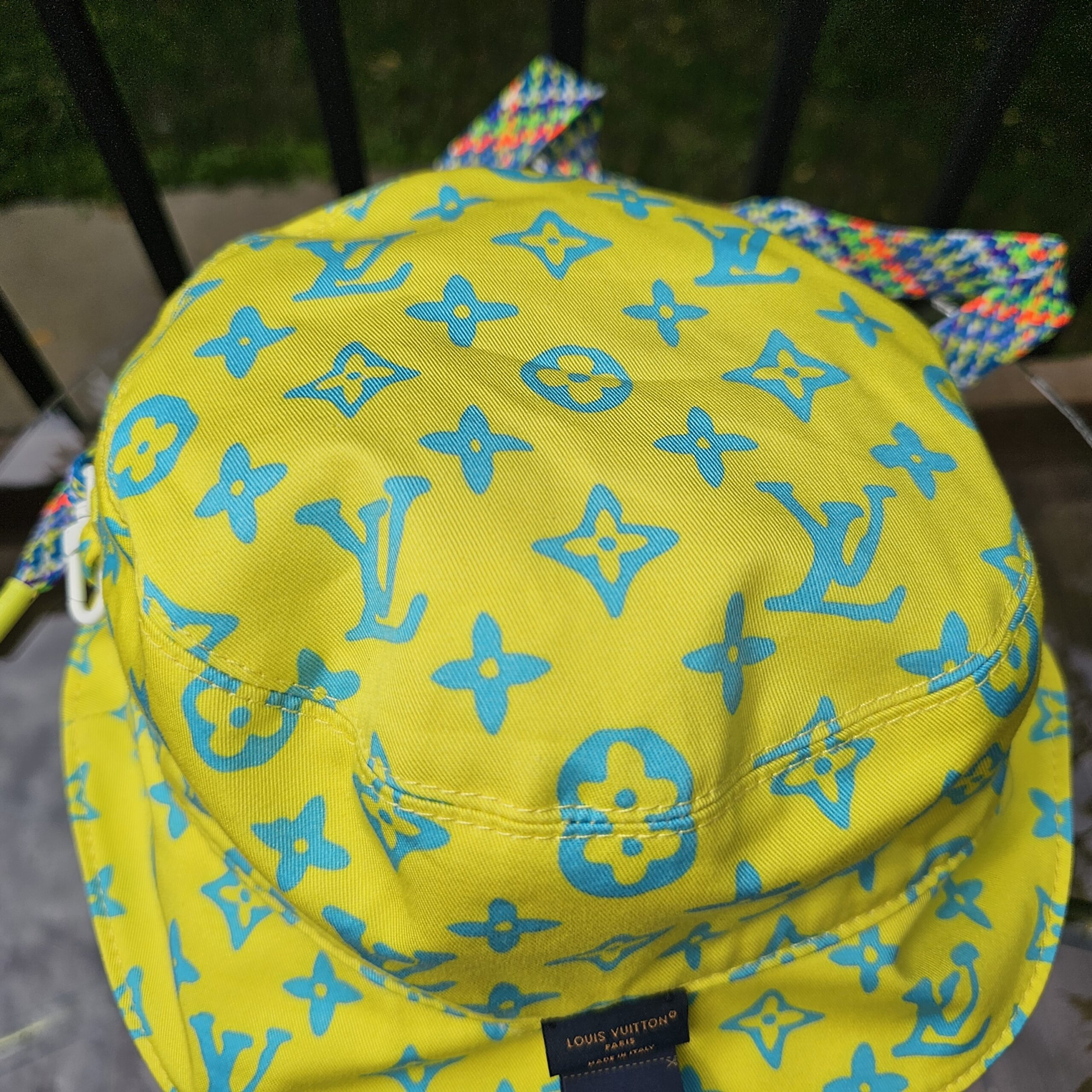 Close-up of the blue Monogram Playground print on the yellow cotton of the Louis Vuitton bucket hat