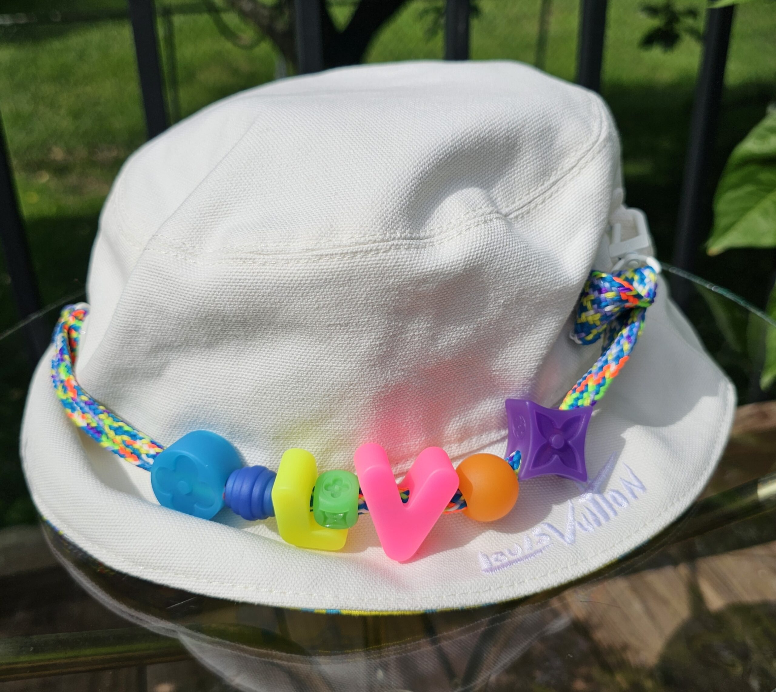 Reverse white side of the Louis Vuitton Virgil Abloh bucket hat with the beaded braided cord