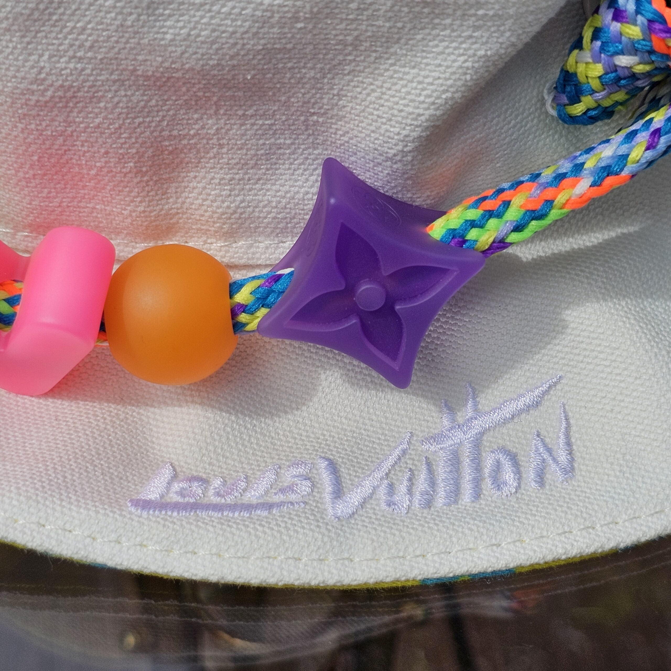 Colorful LV beads on the braided cord of the Louis Vuitton Virgil Abloh bucket hat