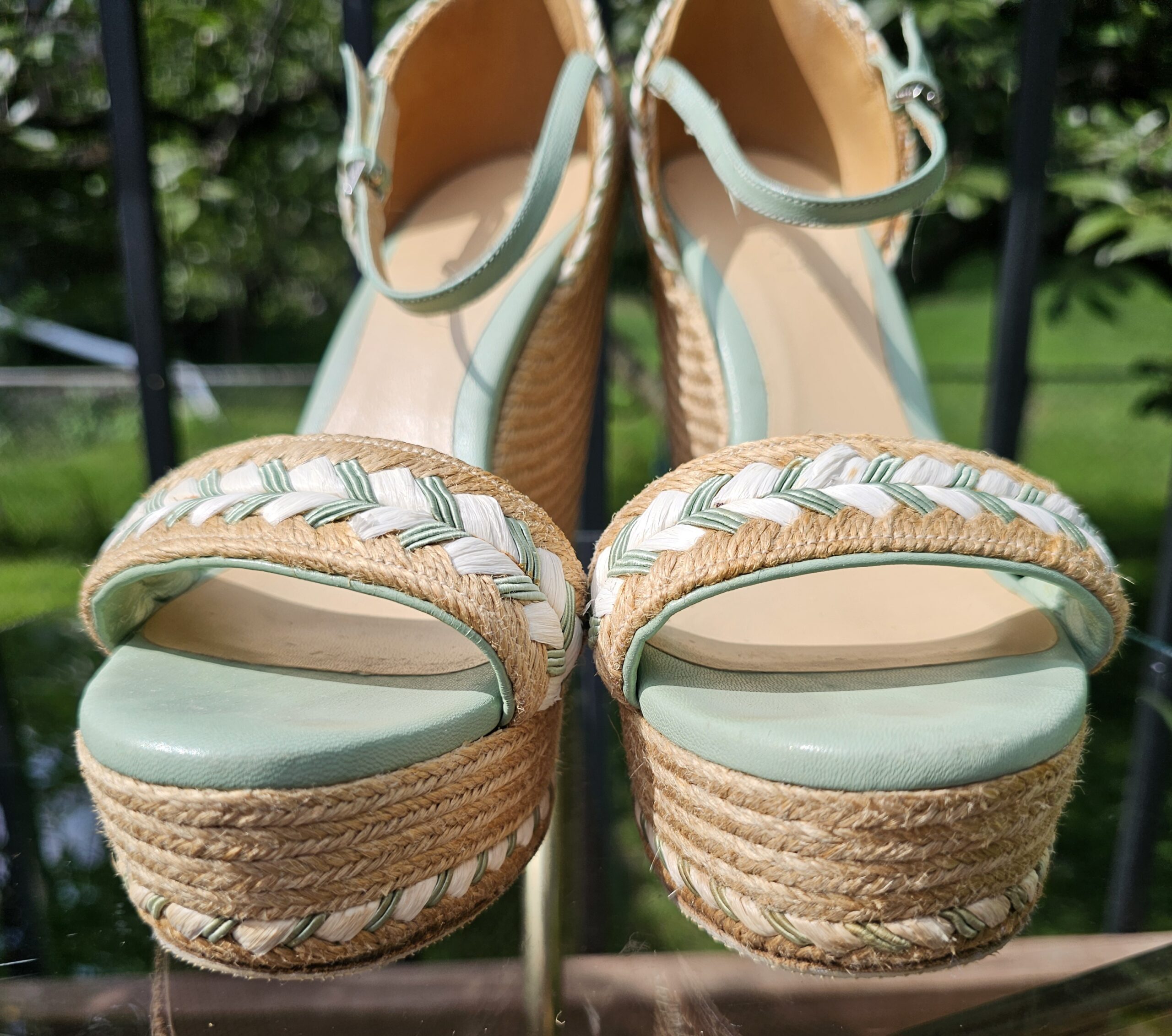 Cream and mint braided trim across the toe straps of the Gucci espadrille wedge sandals