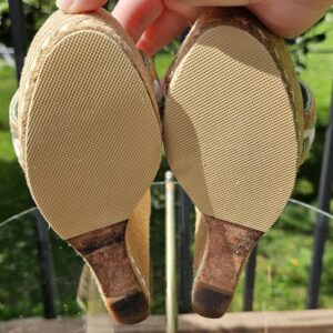 Rubber soles of the Gucci mint green espadrille wedge sandals shown for wear